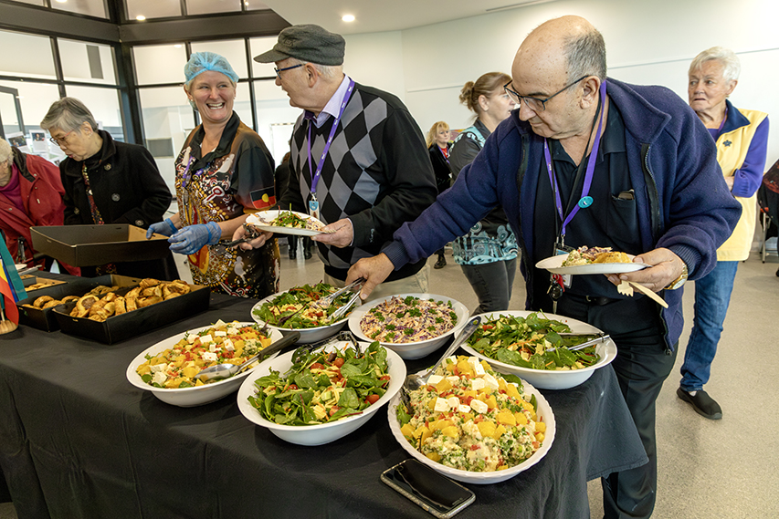 Attendees enjoying a buffet of fresh salads and pastries at Rise’s 2024 NAIDOC celebration.